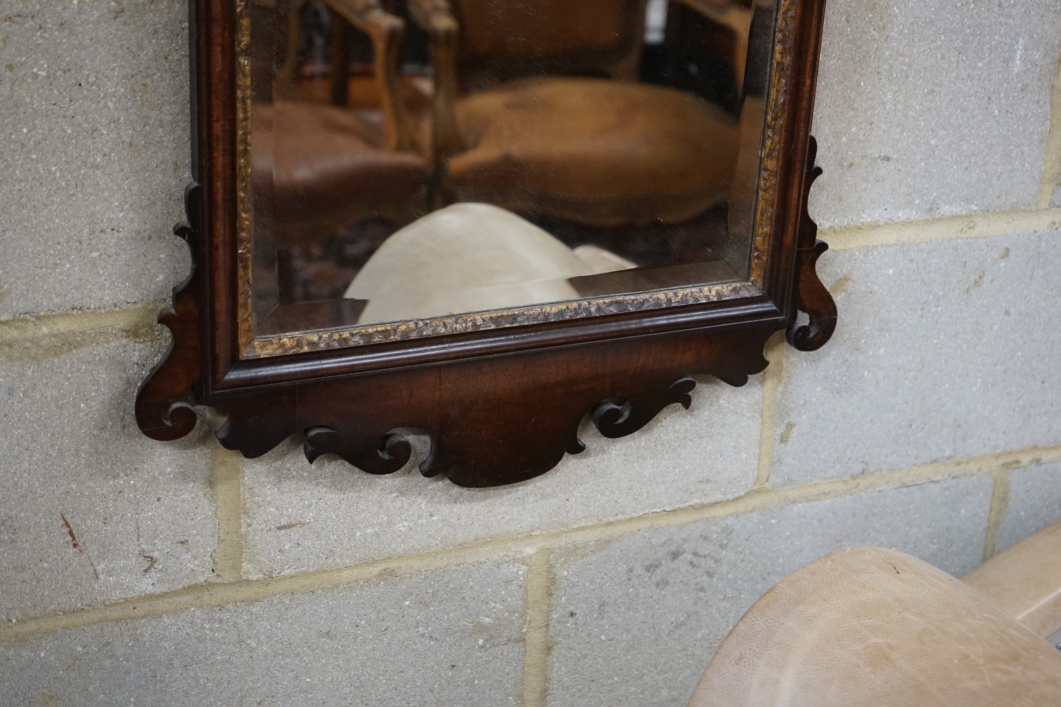 A George III style mahogany fret cut wall mirror, with gilt carved eagle surmount, width 56cm, height 108cm